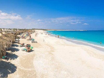 Colorful boat anchored at White Island with tourists enjoying Ras Mohamed & White Island Boat Trip