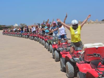 Private family safari riding camels and quad bikes through the desert