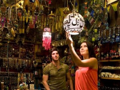 Colorful souvenir stalls and shoppers at Marsa Alam shopping trip