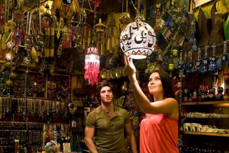 Colorful souvenir stalls and shoppers at Marsa Alam shopping trip