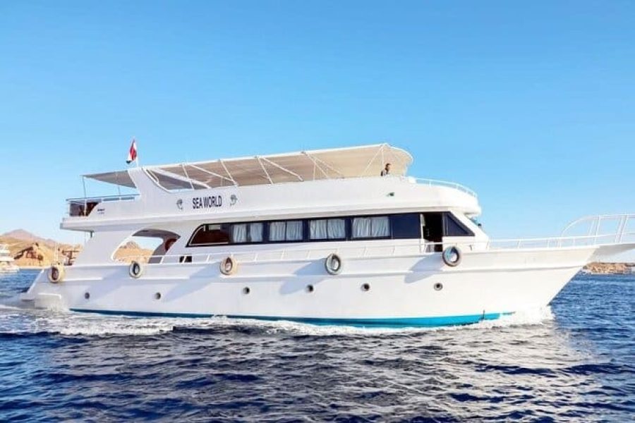 Colorful boat anchored at White Island with tourists enjoying Ras Mohamed & White Island Boat Trip
